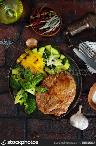 plate of steak with vegetables on plate, top view