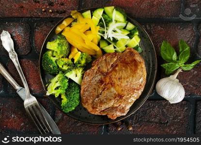 plate of steak with vegetables on plate, top view