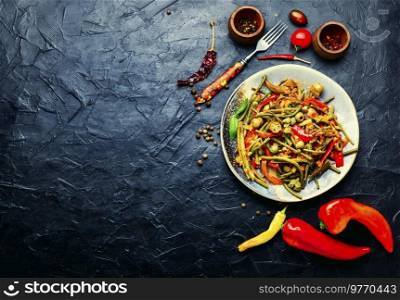 Plate of stewed vegetables with hot spices. Pepper, tomato and asparagus appetizer. Mexican food.. Spicy vegetable appetizer
