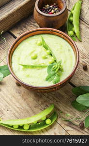 Plate of summer delicious soup with green peas.. Traditional soup with peas