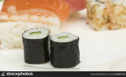 Plate of sushi (shallow dof, focus on the nori-rolls)