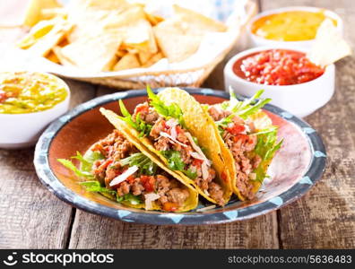 plate of tacos on wooden table