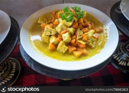 Plate of tofu and carrot in sauce