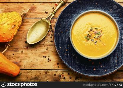 Plate of vegetarian autumn soup puree. Creamy pumpkin soup. Vegetable cream soup.. Autumn pumpkin soup,top view