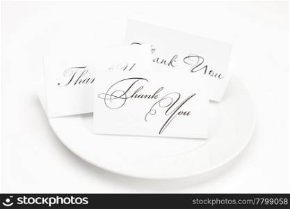 plate with card signed thank you isolated on white