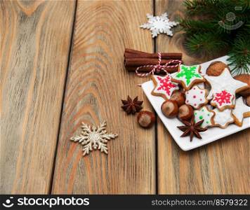 Plate with Christmas cookies and nuts on a old wooden table