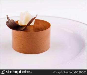 Plate with coffee panna cotta on white