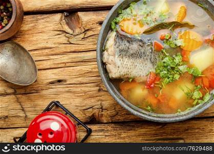 Plate with fish soup on a wooden retro table.Homemade fish soup. Fish soup or chowder