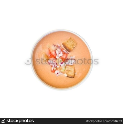 Plate with gazpacho cold vegetable soup with chopped onion, tomato and cucumber isolated on white.