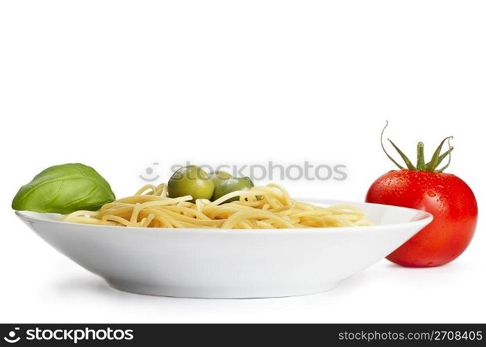 plate with pasta tomato olives and basil. one plate with pasta some olives one tomato and basil
