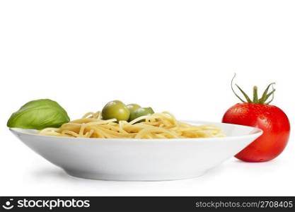 plate with pasta tomato olives and basil. one plate with pasta some olives one tomato and basil