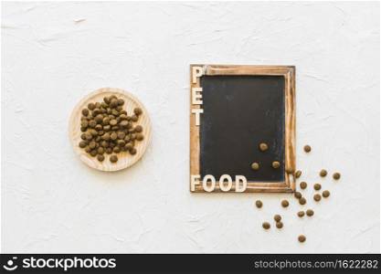 plate with pet food near blackboard writing