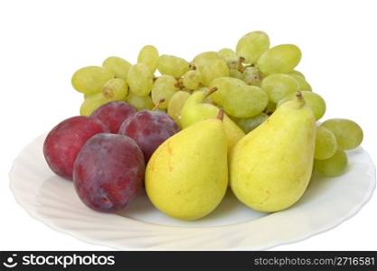 plate with plums, grapes and pears isolated on white background