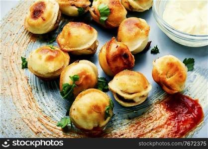 Plate with roasted tasty pelmeni.Fried dumplings.Russian pelmeni or meat dumplings. Delicious fried pelmeni