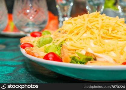plate with salad Caesar on the table