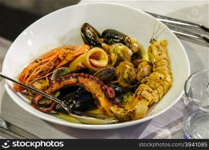 Plate with seafood in traditional Italian restaurant