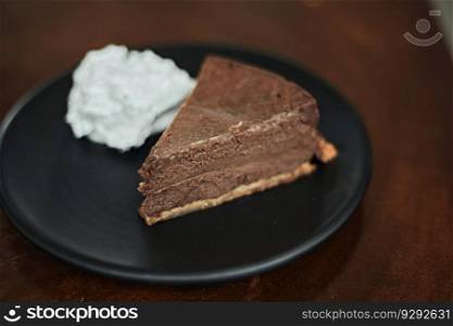 Plate with slice of tasty homemade chocolate cake on table  . homemade chocolate cake on table  