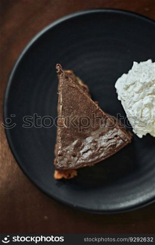 Plate with slice of tasty homemade chocolate cake on table  . homemade chocolate cake on table  