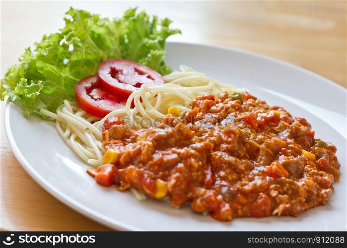 plate with spaghetti, sauce and tomato, italian food
