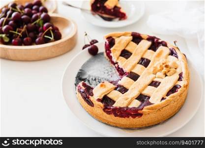 Plate with tasty American cherry pie on white background. Top view. Copy space