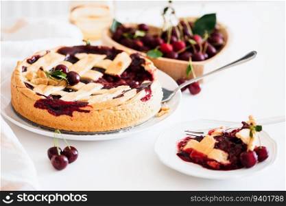 Plate with tasty American cherry pie on white background. Top view. Copy space