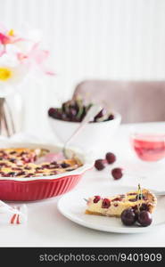 Plate with tasty cherry cheesecake pie on white background