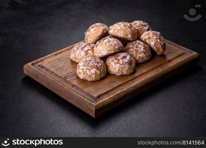 Plate with tasty homemade gingerbread cookies on dark concrete table. Tasty homemade gingerbread cookies on dark concrete table