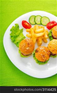 Plate with tasty mini burgers