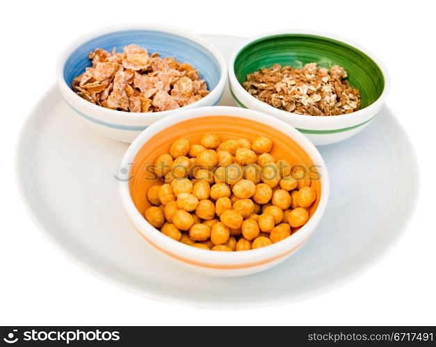 plate with three kind of cereals for breakfast isolated on white
