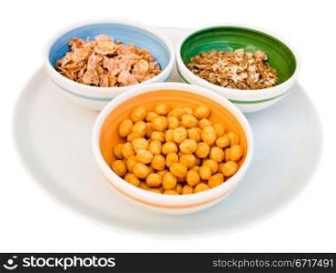 plate with three kind of cereals for breakfast isolated on white