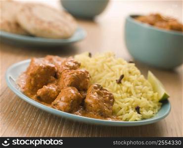 Plated Chicken Korma with Pilau Rice and Naan bread