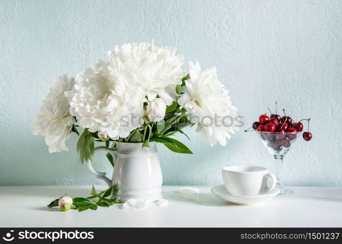 Plateful of cherry and bouquet of flowers. Plateful of cherry and bouquet