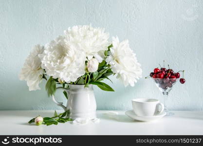 Plateful of cherry and bouquet of flowers. Plateful of cherry and bouquet