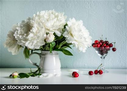 Plateful of cherry and bouquet of flowers. Plateful of cherry and bouquet