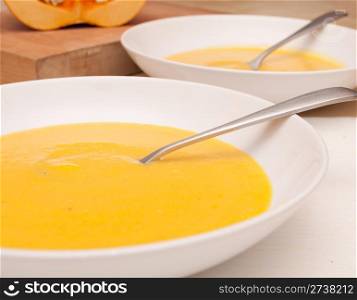 Plates of Butternut Squash Soup on Table