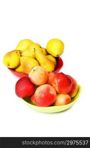 Plates with peaches and nectarines on the white