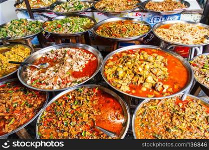 Platters of traditional Thai food for sale on street market stall, Bangkok, Thailand