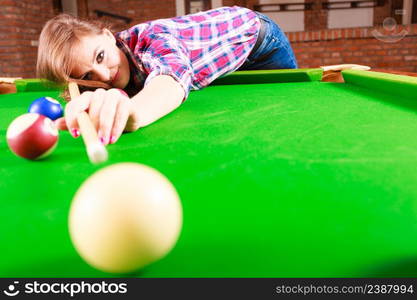 Play and fun concept. Young happy girl having fun with billiard. Smiling fashionable woman playing spending time on recreation.. Young woman having fun with billiard.