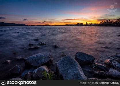 Play of colors at Lake Constance with beautiful clouds and stones 