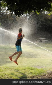 Play with water jets. Children play with jets of water in hot weather