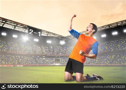 player celebrating goal. soccer or football player is celebrating goal on stadium