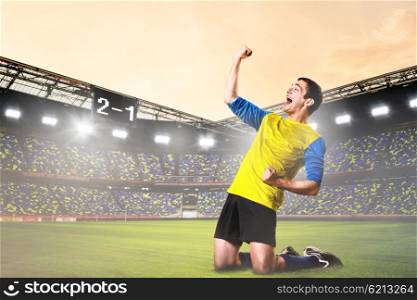 player celebrating goal. soccer or football player is celebrating goal on stadium