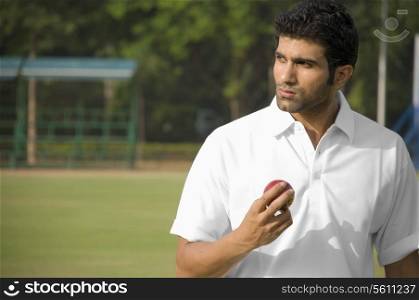 Player holding a cricket ball