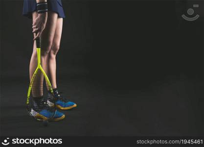 player holding racket her legs. High resolution photo. player holding racket her legs. High quality photo
