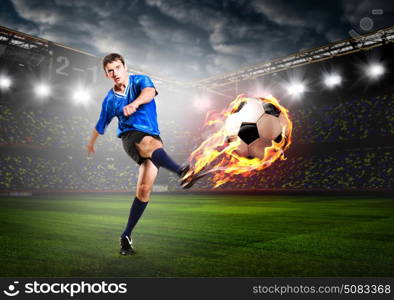 player is kicking ball. soccer or football player is kicking ball on stadium