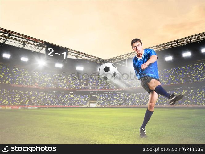 player is kicking ball. soccer or football player is kicking ball on stadium