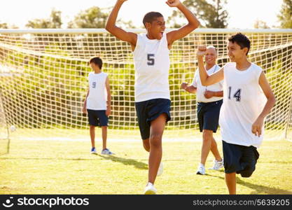 Player Scoring Goal In High School Soccer Match