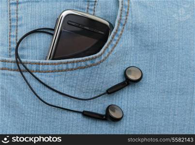 Player with headphones in the pocket of jeans