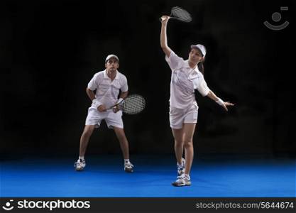 Players playing tennis doubles at court
