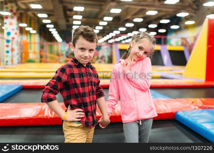 Playful boy and girl in childrens entertainment center. Happy childhood
